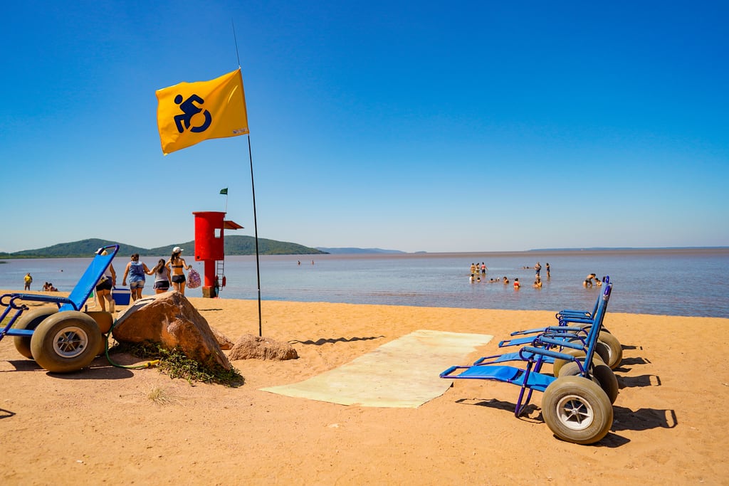 An amphibious beach wheelchair in use at an adapted beach point in Brazil